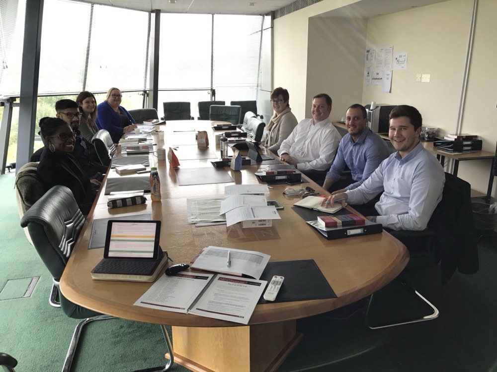 Delegates around a boardroom table during an in-house course